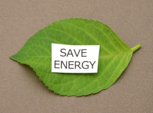 Ein kleines Blatt Papier auf einem größeren Blatt mit der Aufschrift "SAVE ENERGY"